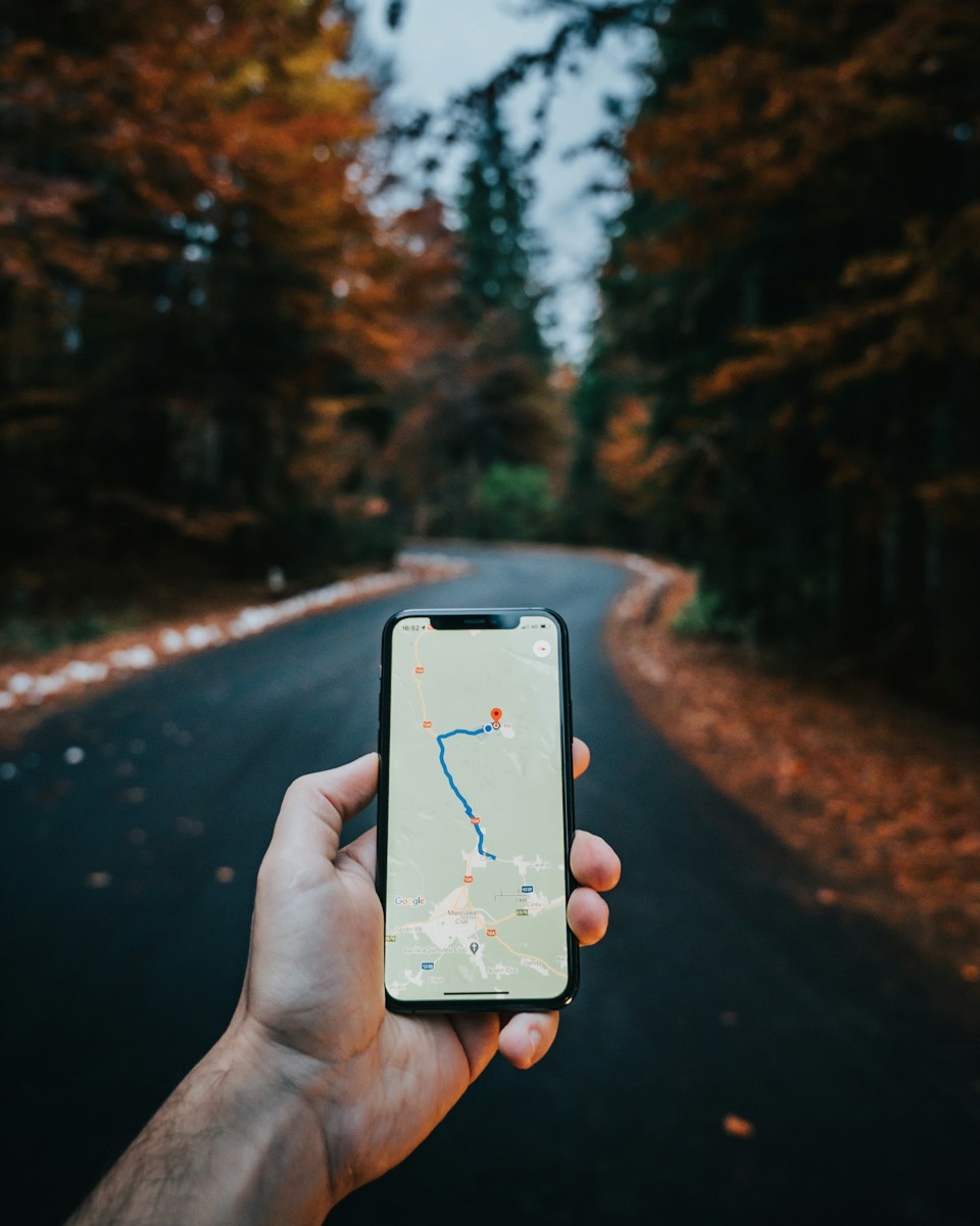 Hand holding a smartphone showing Google Maps navigation, representing local SEO