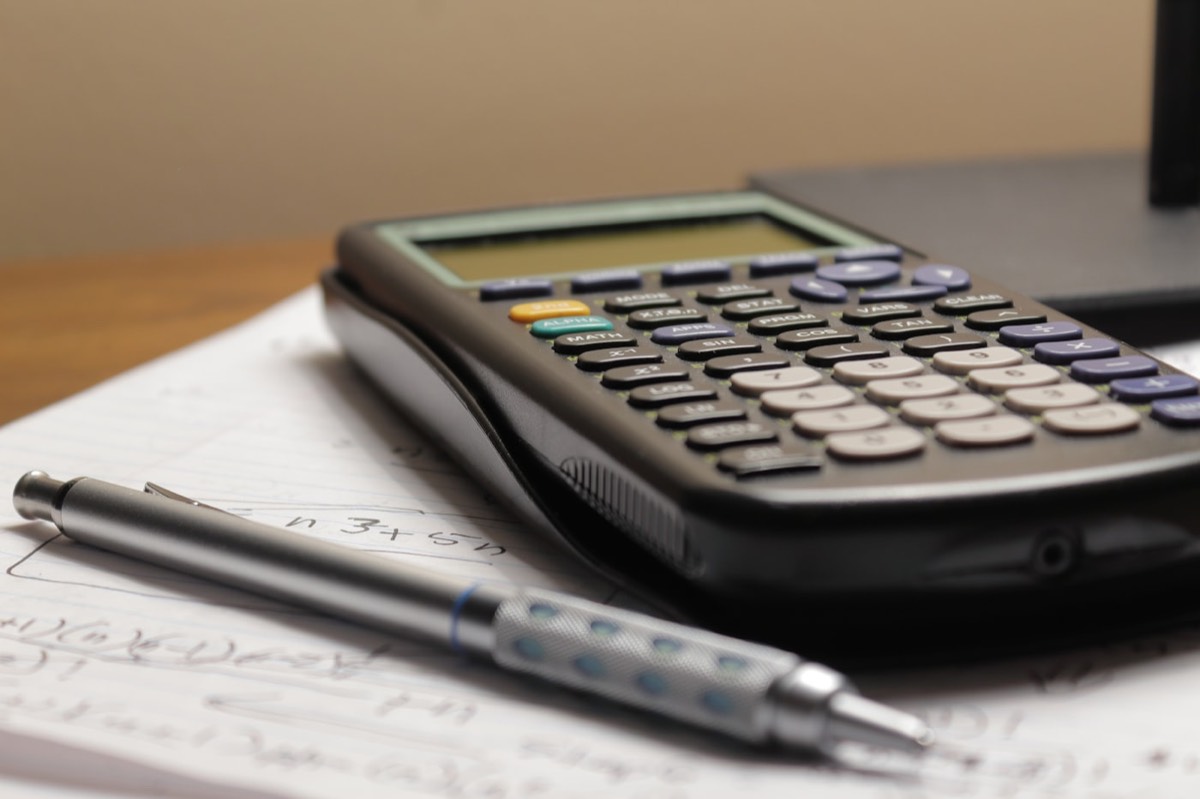 Calculator and pen on a desk, representing SEO pricing in Gurgaon